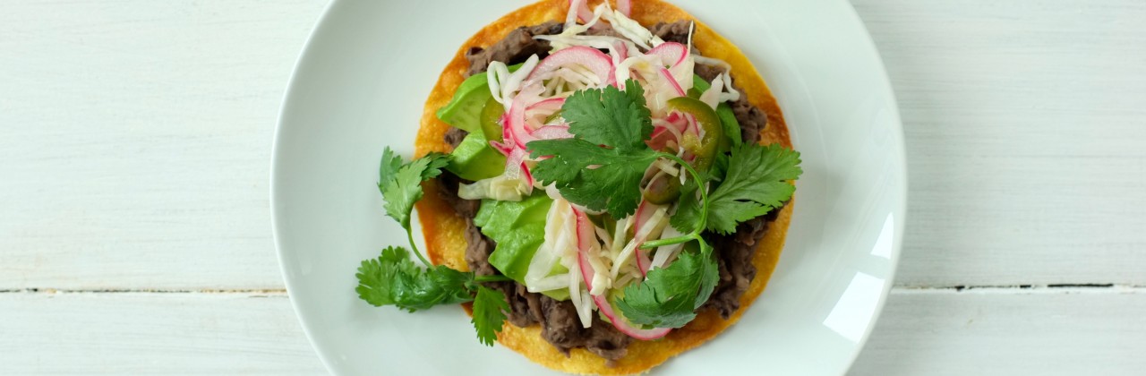 Tostadas with Refried Black Beans and Pickled Cabbage and Onion